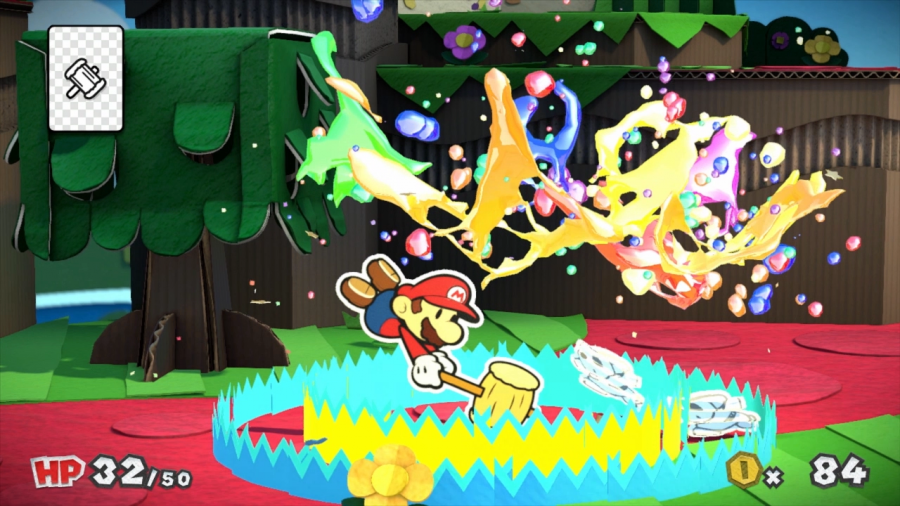 Mario schlägt mit seinem Hammer auf zwei farblose Gegner. Um ihn herum spritzen verschiedene Farben